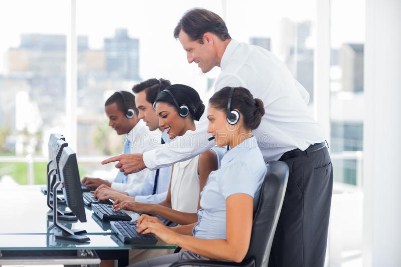 manager-talking-to-his-employees-call-centre-31009509